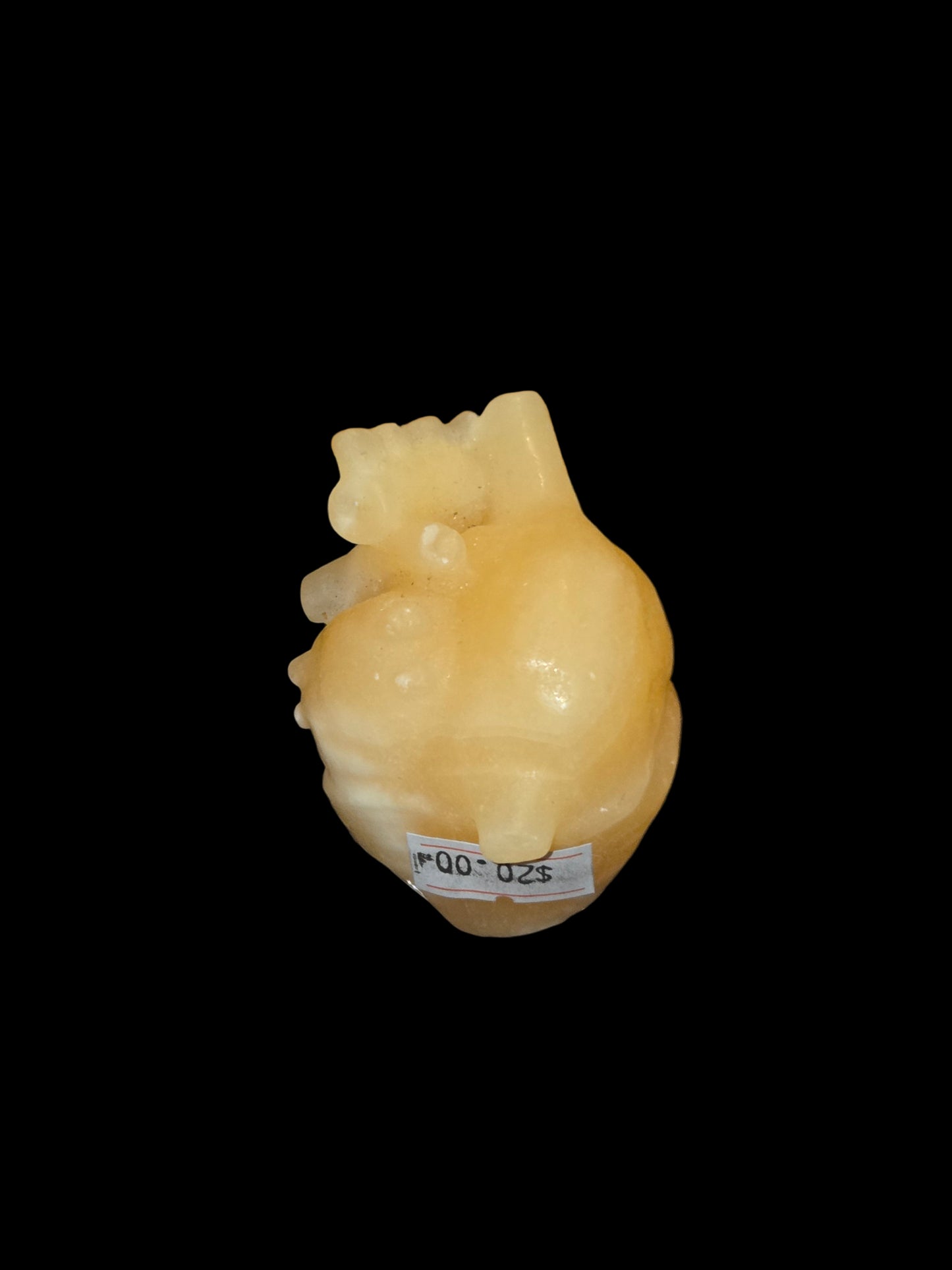 Honey calcite human heart carving