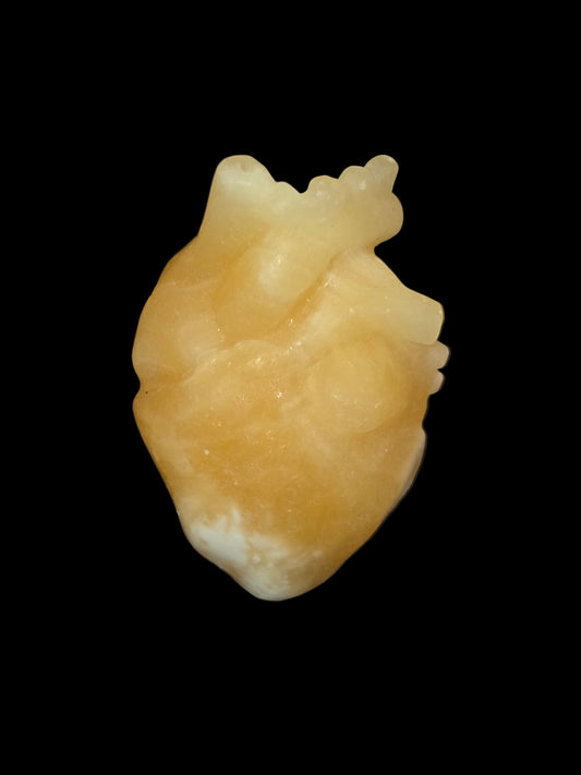 Honey calcite human heart carving
